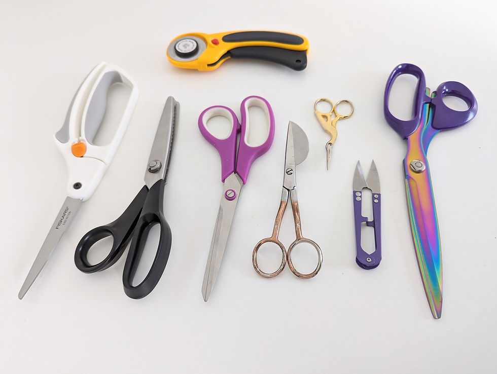 Eight pairs of scissors on a white surface