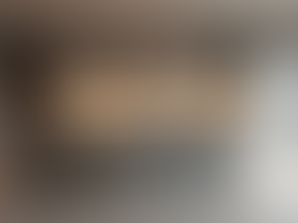 Eye-level view of a modern kitchen island with sleek cabinetry and pendant lighting