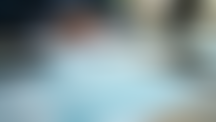 Eye-level view of office desk with payroll documents and calculator