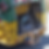 Full black bags of garbage are visible in the back of a yellow and green garbage truck.