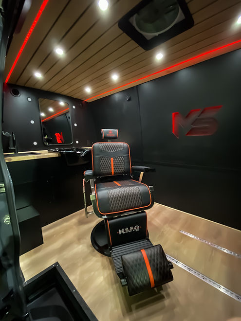 Interior Mobile Barbershop van build including a barber chair, mirror and wash sink