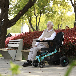 man sitting on bench with wheelchair