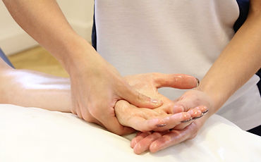 Holding some ones hand putting pressure on a trigger point