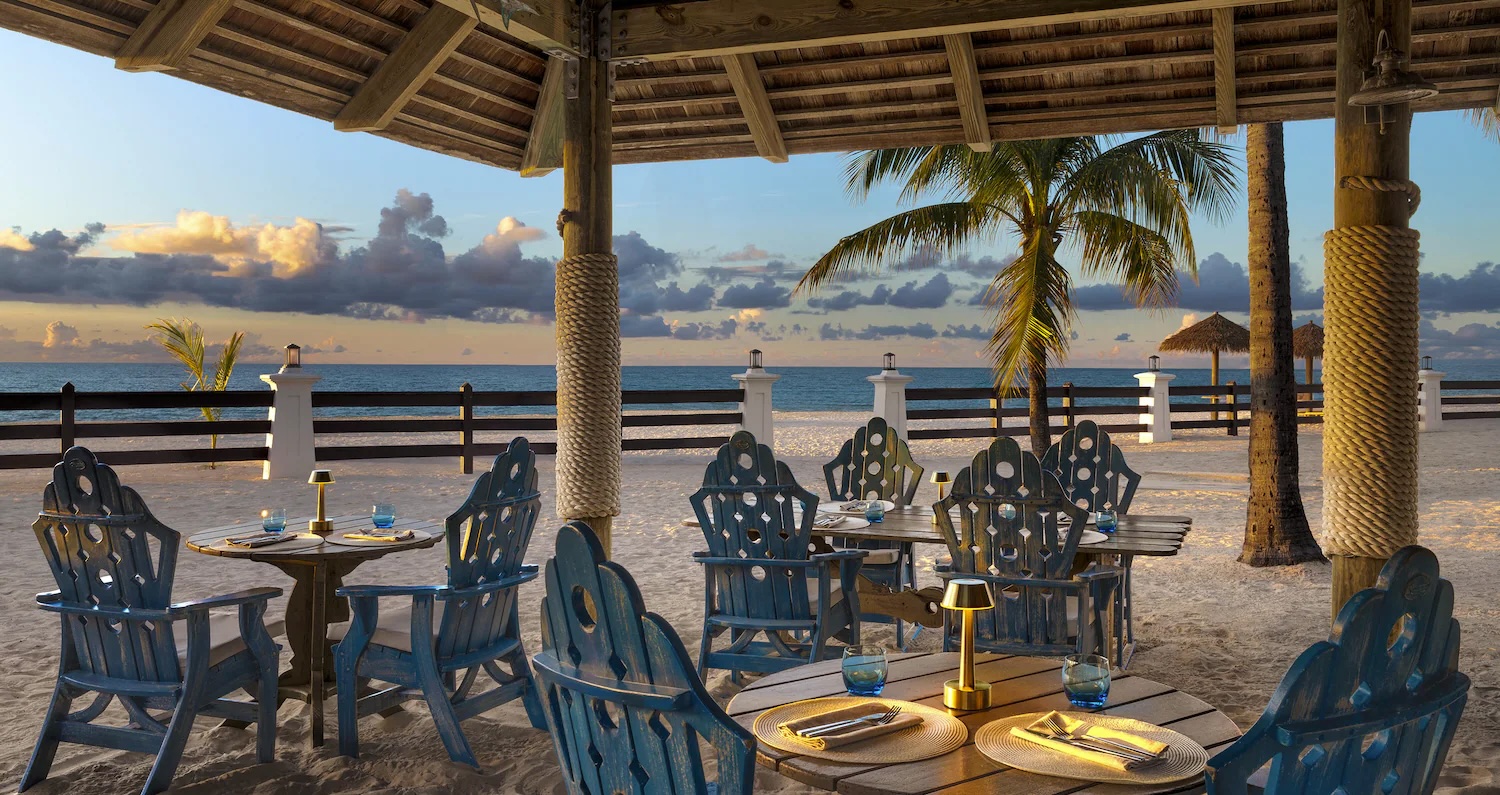 Romantic beach dinner setting at Sandals Grande Antigua