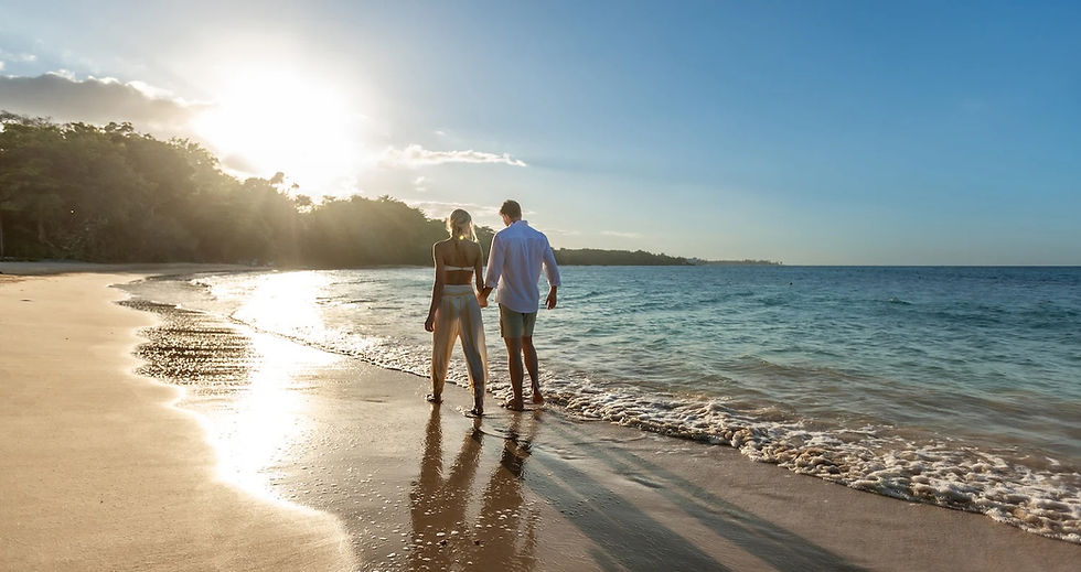 Couple walking on beach at sunset, Bahamas honeymoon