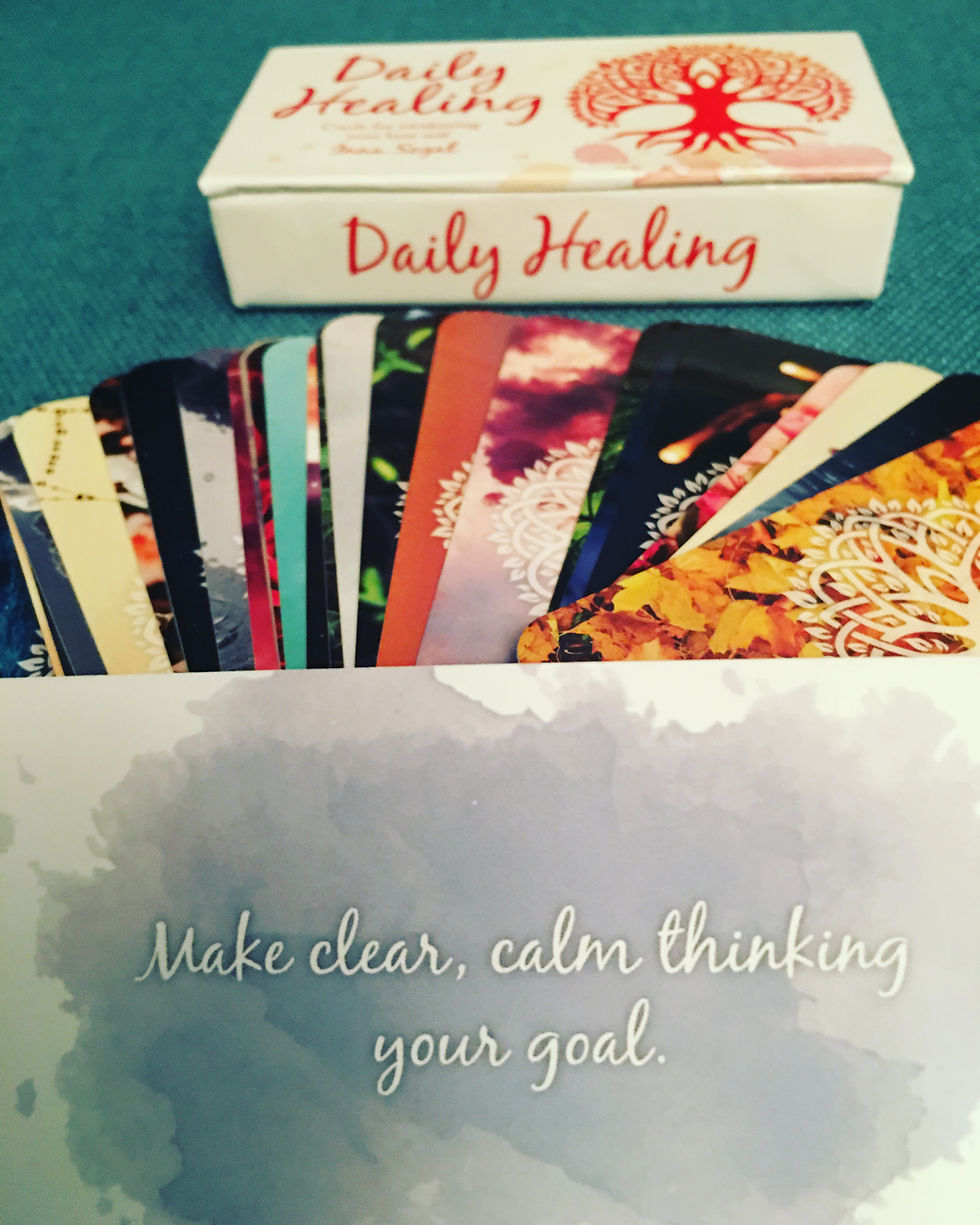 Selected mini inspiration card from the 'Daily Healing' deck: Make clear, calm thinking your goal. Shows a fan of the cards in the background, along with the deck's box. The selected card's text is printed on a lavender background.