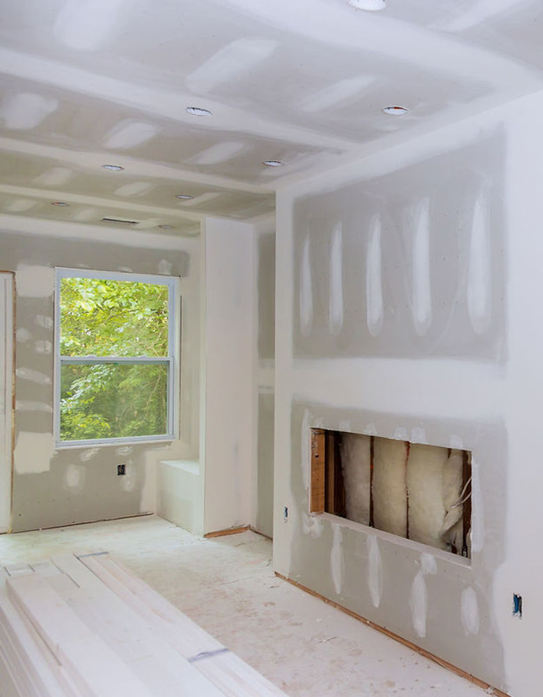 Drywall panels patched and prepared before texture, primer, and paint
