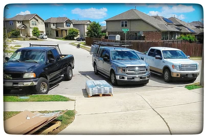 Three handyman trucks parked in a Cedar Park residential driveway, ready for a home repair or remodeling project
