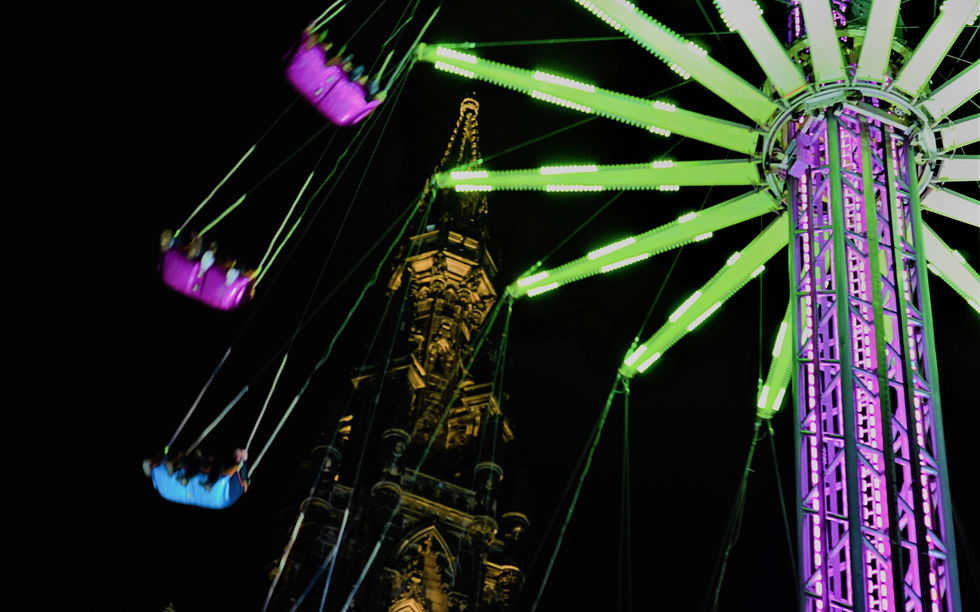 Starflyer at Edinburgh Christmas Market — aerial ride above the city lights with views of the Scott Monument, combining festive atmosphere, height, and motion.