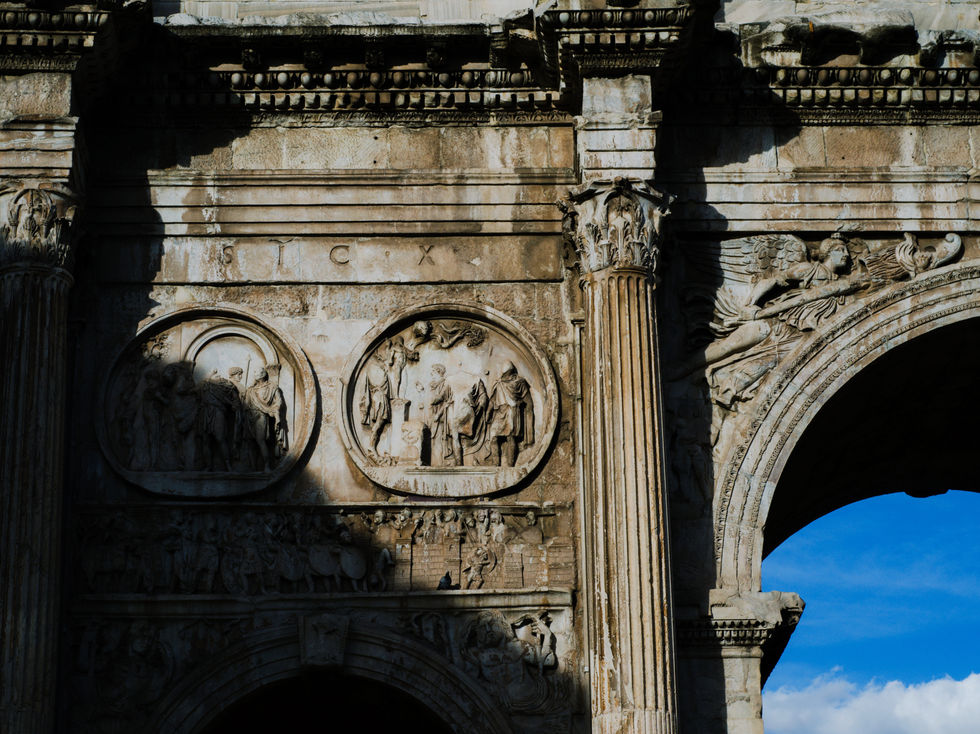 Ancient inscribed stone in Rome, where weathered words reveal the passage of time and the fragility of memory.