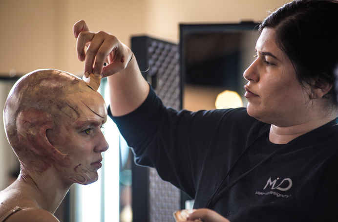 Makeup Artist applying prosthetics for a film