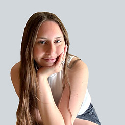 Image of Laura leaning in, resting her hand on her head in a thinking position.
