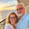 Couple relaxing on a cruise ship balcony at sunrise overlooking the ocean during a peaceful cruise vacation.