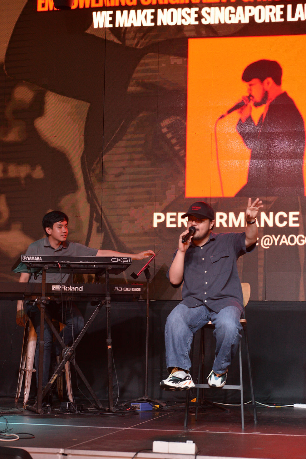 Man speaking to the audience on stage