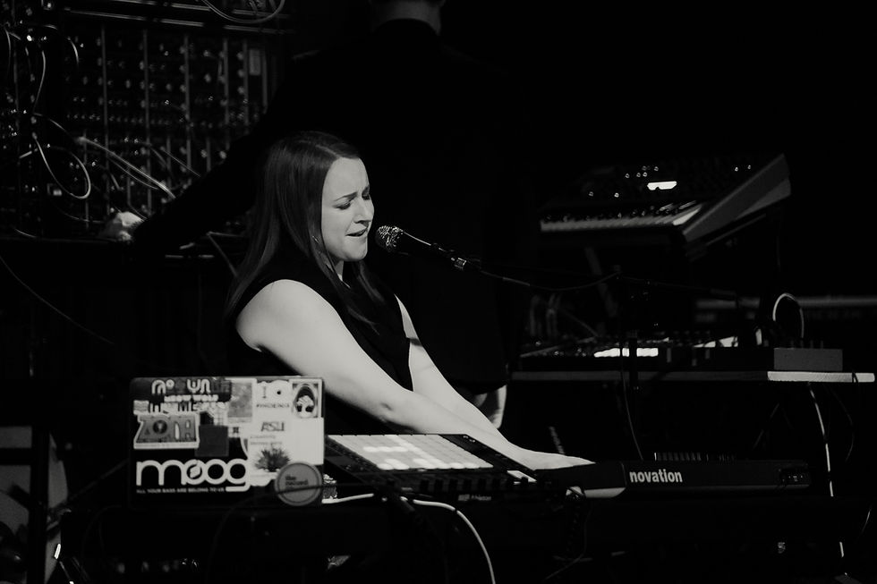 A female musician performing with music gear around her