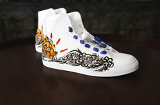 Side view of Martin artwork with lapis lazuli stones and embroidered featherwork.