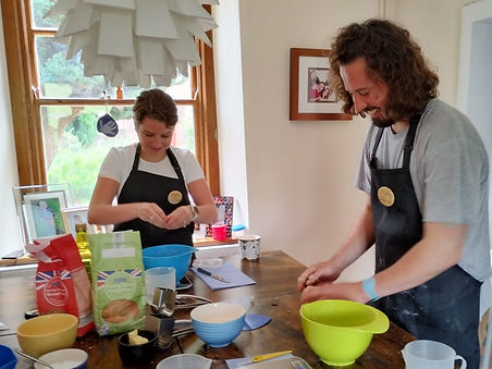 A man and a woman having fun at artisan breadmaking class for beginners