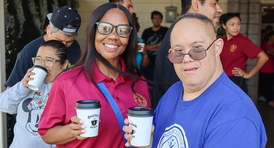 Smiling adult day program participants holding coffee cups.