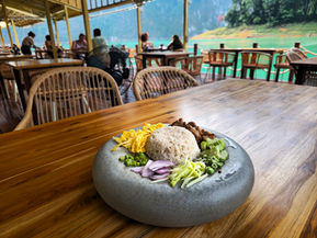 Thai-inspired dining experience overlooking tropical lake scenery