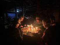 Travelers learning traditional bamboo cooking in Khao Sok rainforest