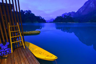 Evening atmosphere over Cheow Lan Lake with floating resort lights