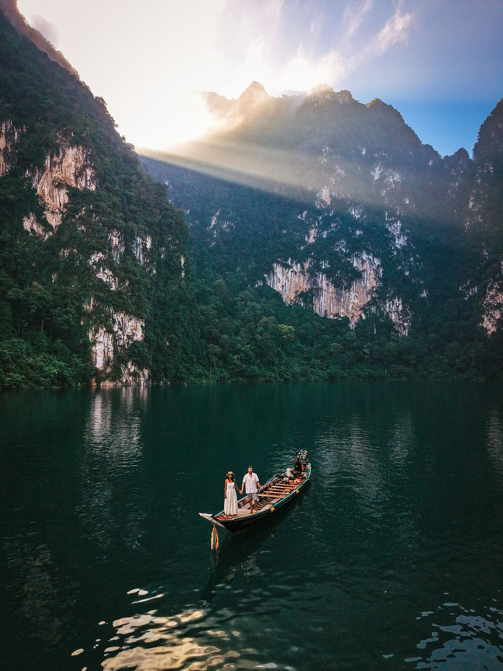 Discover a romantic private longtail boat tour on Chiew Lan Lake in Khao Sok National Park. Explore limestone cliffs, emerald waters, and luxury Khao Sok experiences in Thailand.