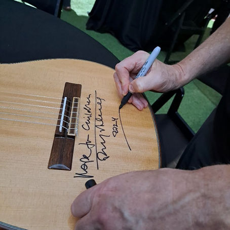 Bryan Adams Signs Guitar to Be Auctioned for Hope For Children