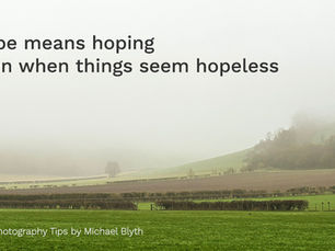 Misty rural landscape with green field, hedgerows and distant hills partly hidden by fog, suggesting hope and clarity still to come