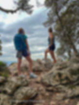 Hikers pause on a rocky viewpoint along the GR221 trail, enjoying the Tramuntana landscape on Mallorca’s GR221 route.