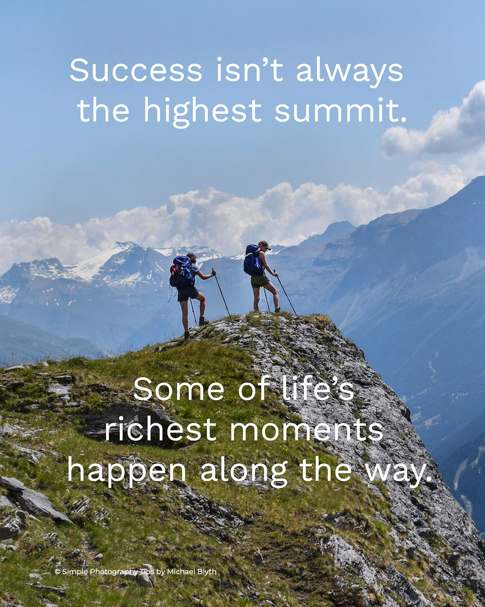 Two hikers with poles on a grassy mountain peak surrounded by clouds and blue sky. Text: "Success isn’t always the highest summit."