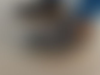 Close up of black and orange Aku walking boots with sand