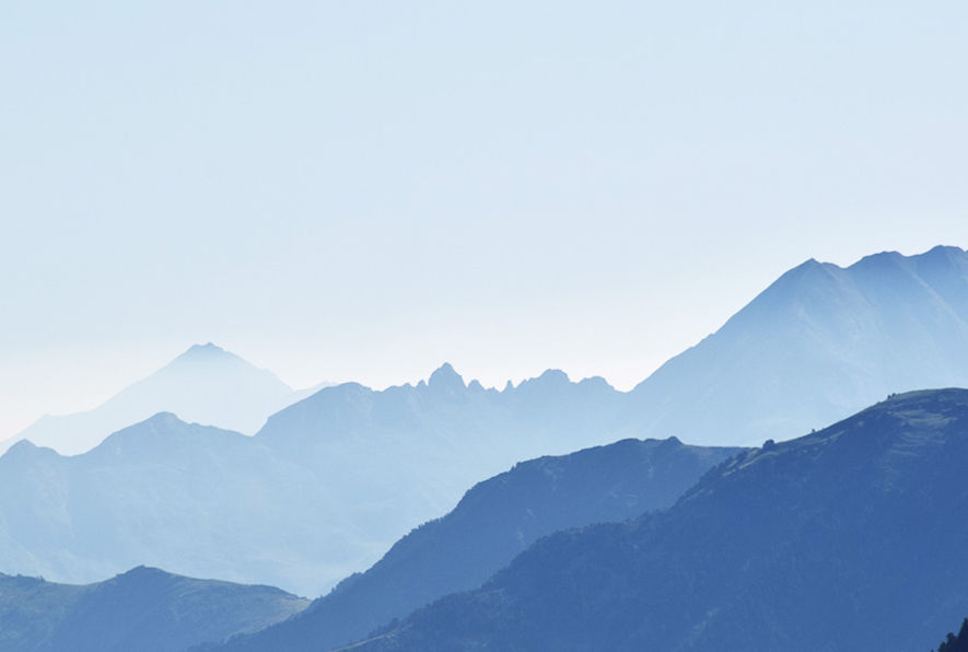 Soft blue mountain layers in the Pyrenees demonstrating visual recession