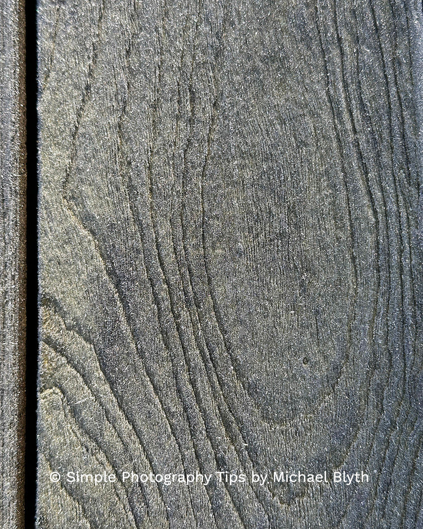 Abstract close-up of frosted teak wood grain with sparkling ice crystals and oval ring patterns.