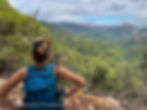 A hiker pauses on the GR221 trail to take in Mallorca’s Tramuntana views