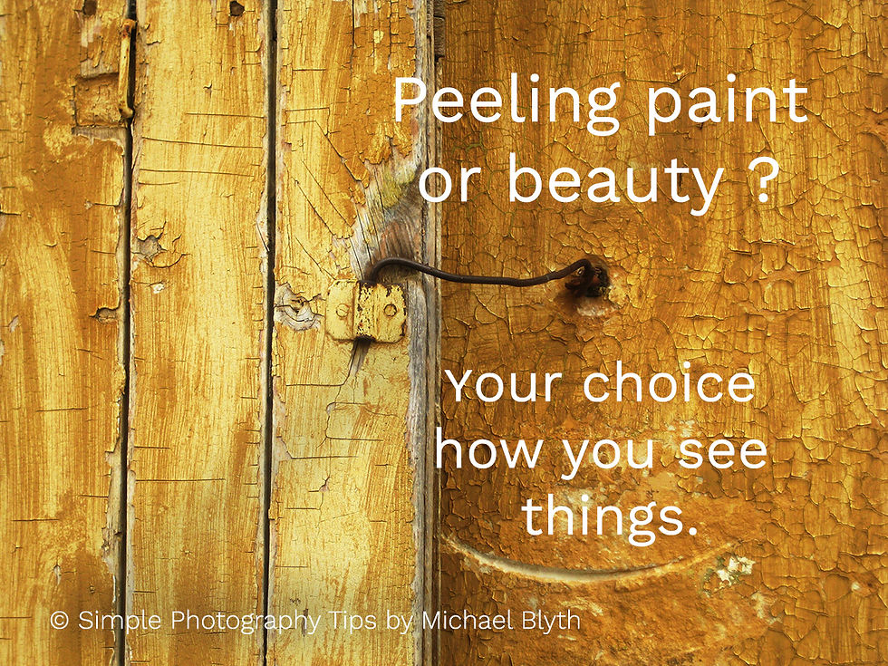 Weathered yellow wooden door with peeling paint and an old metal latch, photographed in soft natural light