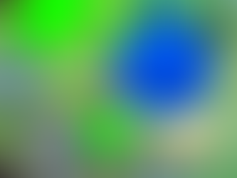 Close-up photograph of sea glass from North Devon glowing green, blue and orange under ultraviolet light, revealing colours not visible in ordinary daylight.
