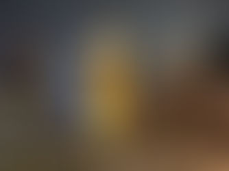 Elizabeth Tower and the London Eye at blue hour in London demonstrating warm building lighting against a cool evening sky.