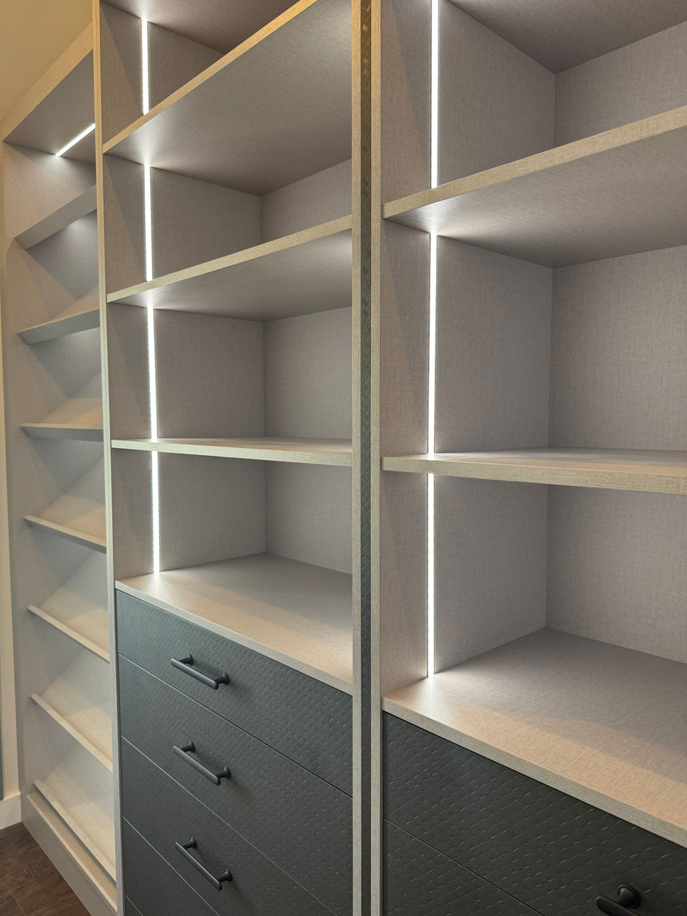 Modern dressing room shot of display shelving and drawers with LED lighting