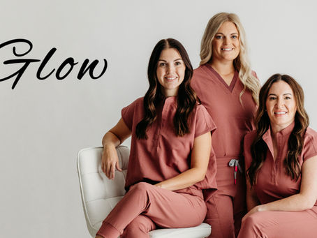 three women in pink scrubs smiling