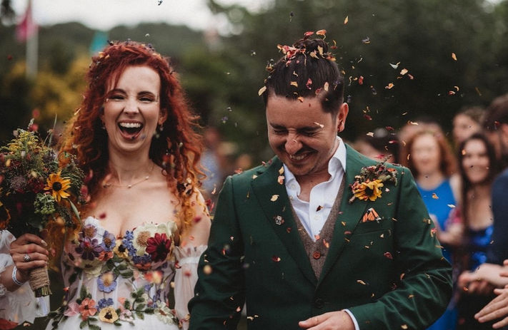 Confetti covered wedding couple