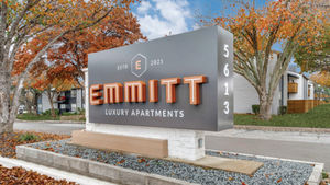 Emmitt Luxury Apartments monument sign with modern branding and landscaped surroundings