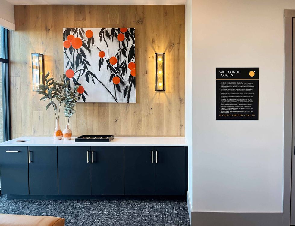 Interior leasing office with branded artwork and modern cabinetry