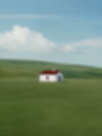Image of farmhouse on vast green field