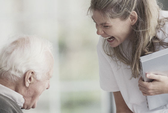 elderly man and nurse smiling