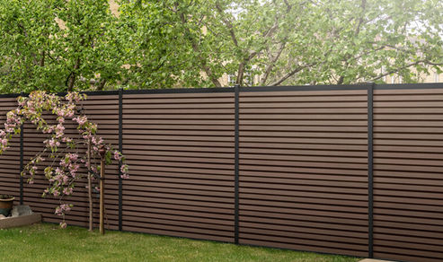 Composite fencing with metal posts by Composite Prime, available from Essex Decking and Fencing.