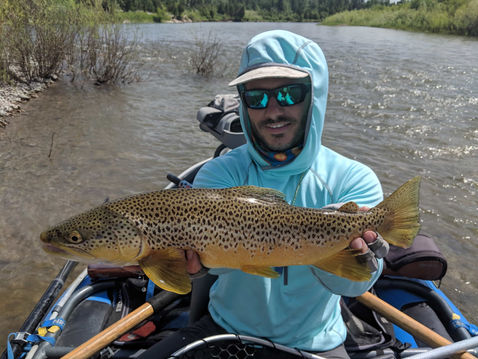 Photo of a fisherman holding a caught fish