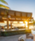 Outdoor bar with ocean view at sunset