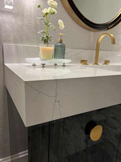 Modern bathroom sink with  marble counter top. gold faucet and accessory decor.