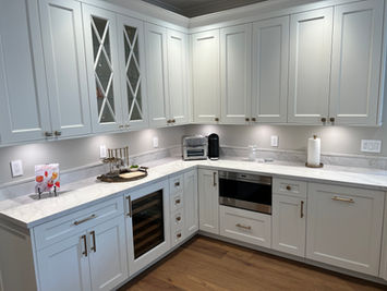 White kitchen cabinets with appliances and countertops in a modern home.