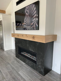 Modern fireplace with a zebra picture and wooden mantel, interior design photo.